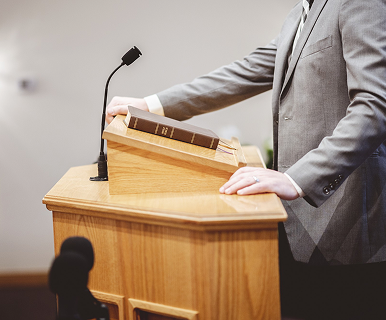 Christian speaker at a podium